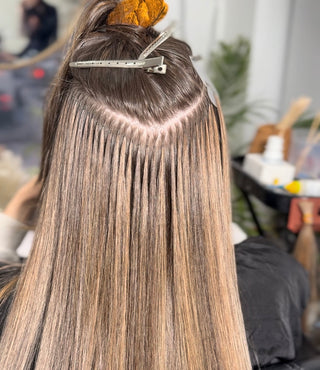 A smiling woman with long, flowing Ice Fusion hair extensions.