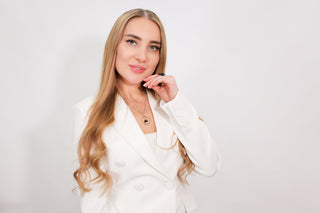 A woman smiling, showing off her long, healthy hair extensions.