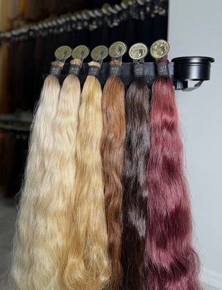 Silky, wavy premium hair bulk in ombre, blonde, brown, and burgundy — double drawn, 100% human hair with natural shine and texture