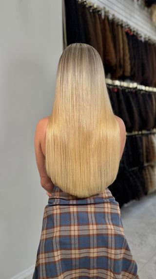 Confident woman smiling and flipping her long, voluminous hair.